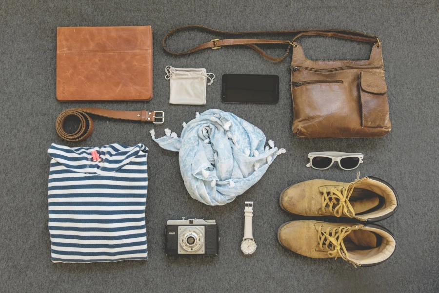 Clothing, shoes, handbags, watches and accessories arranged together